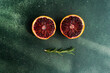 © ADDICTIVE STOCK - Fresh blood oranges and rosemary on green surface