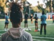 A sports coach emphasizing the importance of mental wellness for athletes