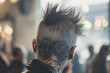 Close-up of a man's edgy mohawk haircut and artistic scalp tattoo in a blurred indoor setting