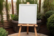 Rustic wooden easel with whiteboard canvas in a garden setting.