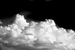 White cloud on a black background. The color contrast creates a striking visual effect. Symbolizes purity and simplicity. Induces a feeling of calm and tranquility.