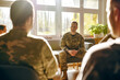 © Garnar - Man soldier sits facing the group of male veterans, sunlight from the surrounding windows. Sense of calm and unity prevails. Concept of military support groups aiding mental health recovery, therapy
