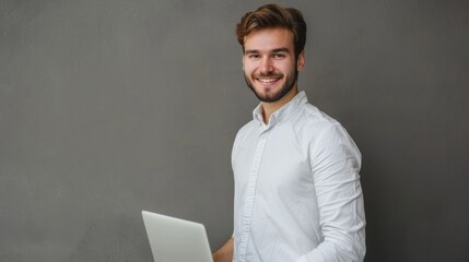 Aufkleber - Angry young businessman with light shirt posing on grey wall background. Achievement career wealth business concept. Render of copy space. Hold laptop.