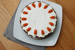 Top view of carrot cake with mascarpone cream cheese icing and handmade mini marzipan carrot decorations