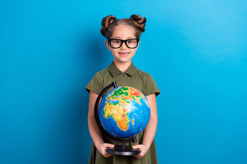 Wall Mural - Photo of sweet lovely schoolkid hold round big globe show map continent wear t shirt isolated blue color background