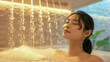 Serene Asian woman enjoying a luxurious shower bath, peaceful spa concept.