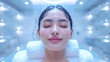 Close-up of a refreshed young woman with water droplets on her face, serene beauty concept.