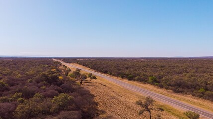 Aerial view of a highway road in the middle of the field