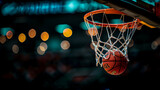 Fototapeta Sport - Sport action photography. A basketball going through the net in an indoor setting