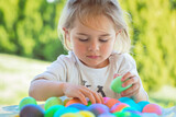Fototapeta Dmuchawce - Little Boy Coloring Easter Eggs