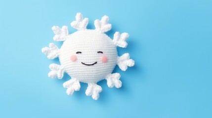 Wall Mural - Knitted, cute sun with a smile on a blue background, top view, with space for text. Greeting card, hobbies, knitting, children's toys.