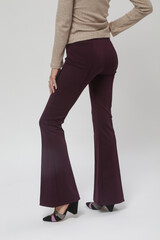 serie of studio photos of young female model wearing basic flared purple trousers and triangle heel 