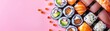 A plate of assorted sushi with a pink background