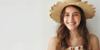 Full length photo of a beautiful young woman with a smile in a straw hat against a white wall with copy space on the left, banner