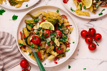 Canvas Print - Pasta Primavera, vegetables pasta with zuccini, tomato  and lemon .top veiw.selective focus