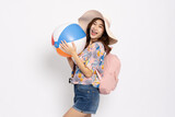 Fototapeta  - Happy Young Asian traveler woman wearing floral dress smiling with backpack and holding beach ball isolated on white background, Tourist in summer and holidays vacation concept