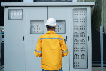 Electrical Engineer Monitoring Systems on Laptop