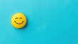 A yellow smiling face badge on a blue background