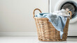Laundry basket on white background of modern washing machine
