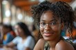 © Larisa AI - Portrait of a happy young female student with glasses smiling in a classroom