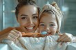 © Larisa AI - Smiling young mother and daughter brushing teeth together in a bright bathroom