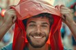 Cheerful man in red shopping bag on head closeup personal style lively street amused onlookers
