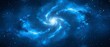   A large blue spiral in the night sky, surrounded by stars on its periphery