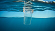 plastic cup floating underwater in the ocean sea pollution by garbage plastic problem