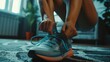 Person lacing up blue sports shoes on carpeted floor. Home workout and fitness motivation concept