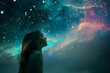 A little girl looking at the galaxy and the stars in the sky