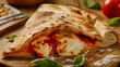 Delicious calzone with melted mozzarella cheese and spicy filling, baked until golden crisp on table in an Italian trattoria, menu or advertisement for the delivery of fresh pastries from a pizzeria