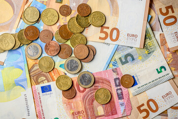 Wall Mural - EU euro coins on heap of euro bills. EU economy and finance. Cash money. Currency background. Close up view.1