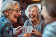 © Emanuel - Seniors enjoying a card game, sharing laughs in a retirement home, highlighting the community's warm and engaging atmosphere