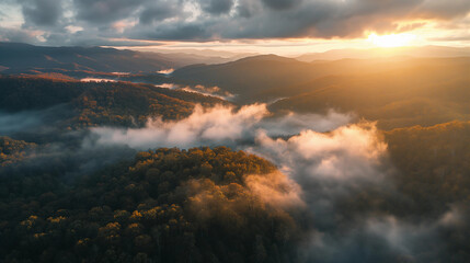 an aerial view of a foggy morning over a forest or mountain