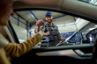 © DusanJelicic - Sealing the deal with a smile: A white mechanic passes car keys to a happy customer, embodying quality service and customer satisfaction in the workshop.