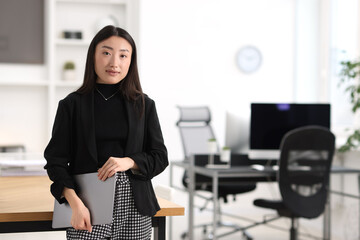 Poster - Portrait of beautiful businesswoman with laptop in office. Space for text