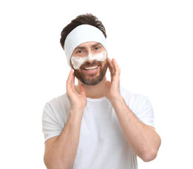 Wall Mural - Man with headband washing his face on white background