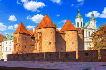 Cityscape with historic medieval fortification building Warsaw Barbican and Church of the Holy Spirit in Warsaw, Poland