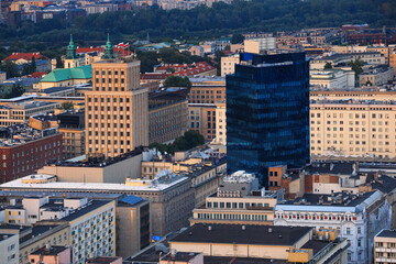 Wall Mural - Cityscape at sunset - top view of the neighbourhoods of Centrum and Powisle, located within the Srodmiescie district in central Warsaw, Poland