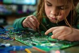 Fototapeta  - child girl is engaged in robotics and microelectronics. Children's lesson. Physics. Hobby. radio engineering