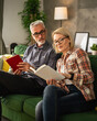 © Miljan Živković - mature senior couple man and woman husband and wife read book at home