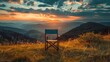 Solitary folding chair facing a stunning mountain sunset