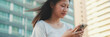 © Andrii Nekrasov - Beautiful brunette girl dressed in casual clothes, uses mobile phone, Panorama