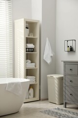 Poster - Stylish bathroom interior with grey chest of drawers and shelving unit