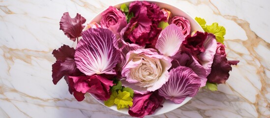 Wall Mural - A beautiful arrangement of colorful flowers is placed in a decorative bowl on a sleek marble table