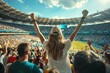 A woman is standing in a stadium with a crowd of people around her. Football fan at the football championship