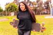 Confident young woman with skateboard outdoor