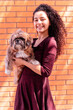 Cheerful young woman with fluffy dog