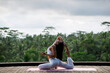 © Evgenii - A beautiful young girl, of European appearance, brunette, doing yoga, wearing a white yoga suit.