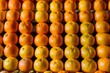 Oranges neatly arranged on market stall, colorful fruit display photo